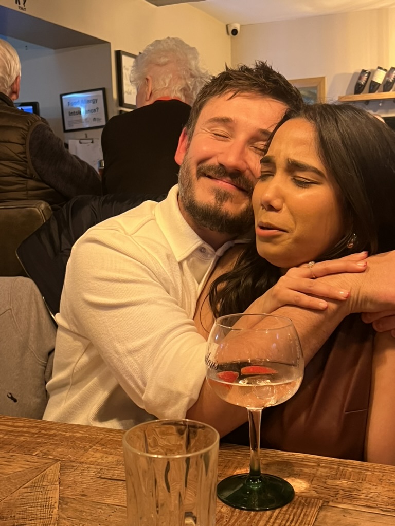 Mansi and Chris sharing a hug at a restaurant